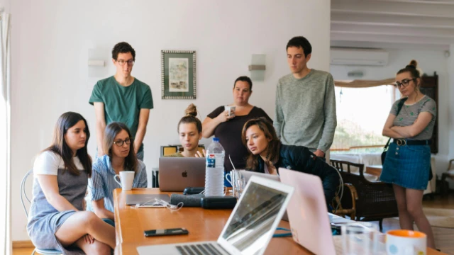 Grupo de empleados revisando opciones de deducible en exceso para gastos médicos mayores en México.