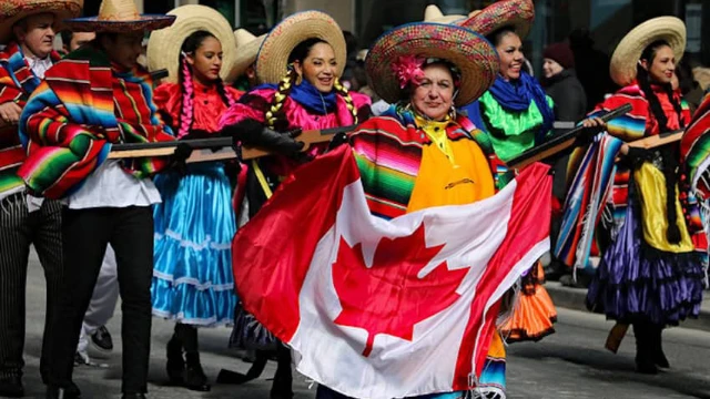 Group of people in Mexico holding a Canadian flag representing Canadian expats