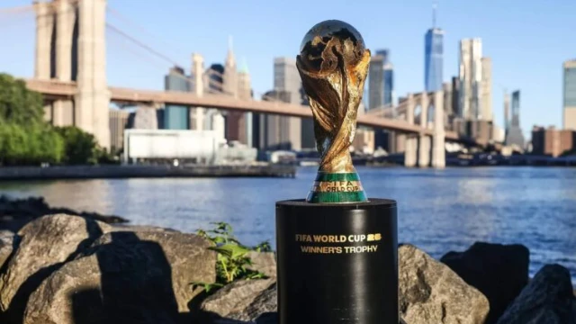 FIFA World Cup 2026 trophy displayed with the New York City skyline in the background