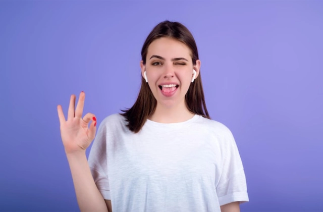 Woman making an OK gesture while smiling confidently about simple travel insurance requirements for the FIFA World Cup 2026.